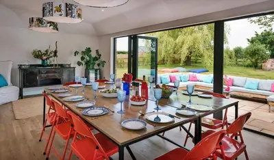 a dining room with a table with red chairs at Finest Retreats - Fox and Hare in Shrawardine