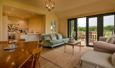 a kitchen and a living room with a table and chairs at Finest Retreats - Fox and Hare in Shrawardine