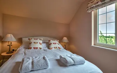 a bedroom with a bed with towels on it at Finest Retreats - Fox and Hare in Shrawardine