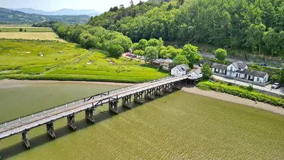 an aerial view of a bridge over a river at Finest Retreats - Toll Bridge Cottage in Dolgellau