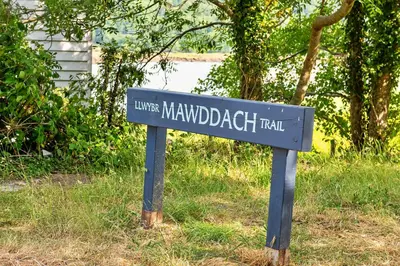 a blue street sign in the middle of the grass at Finest Retreats - Toll Bridge Cottage in Dolgellau
