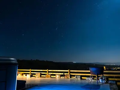 a chair sitting on top of a deck at night at Ceunant in Aberystwyth