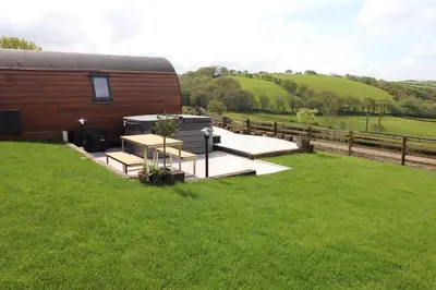 a house with a grassy yard next to a fence at Creuddyn in Aberystwyth