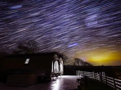 a starry night sky with millions of stars over a house at Creuddyn in Aberystwyth