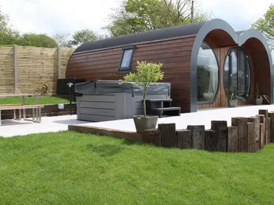 a tiny house with a grill in a yard at Creuddyn in Aberystwyth