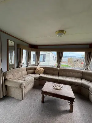 a living room with a couch and a coffee table at Beautiful 2 bedroomed mobile home in Aberystwyth