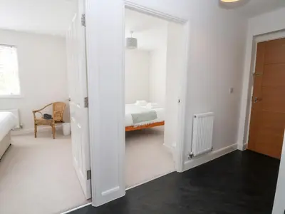 a bedroom with a door leading to a bed at 122 The Old Meadow in Shrewsbury