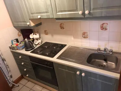 a kitchen with a stove and a sink at Sayang House in Church Stretton