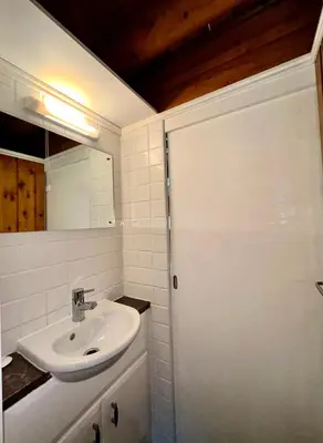 a white bathroom with a sink and a mirror at Snowdonia Escape in Trawsfynydd