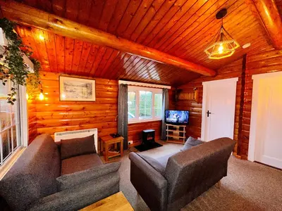 a living room with a couch and a tv at Snowdonia Escape in Trawsfynydd