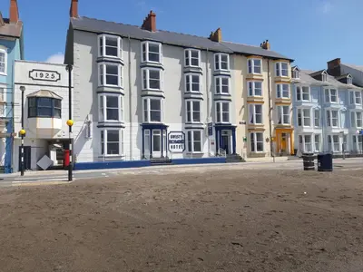 a large white building on a city street at Richmond Hotel in Aberystwyth
