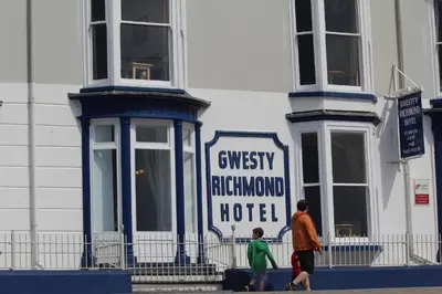 a man and a boy walking in front of a hotel at Richmond Hotel in Aberystwyth