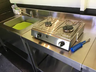 a stove top oven sitting on top of a kitchen counter at Foxgloves and Fairytales Hut with Hot Tub in Llanwrda