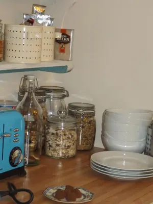 a kitchen counter with jars and plates on a table at The Swallows Guest House in New Quay