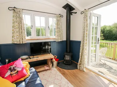 a living room with a couch and a wood stove at Mucklewick Hollow in Shrewsbury
