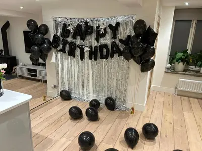 a bunch of black balloons on the floor of a room at Ty Hobi Bach - at the foot of the Black Mountains in Brecon