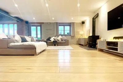 a large living room with a couch and a fireplace at Ty Hobi Bach - at the foot of the Black Mountains in Brecon