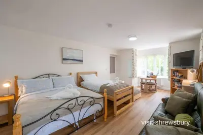 a bedroom with a bed and a couch at Personal En-suite in Shrewsbury
