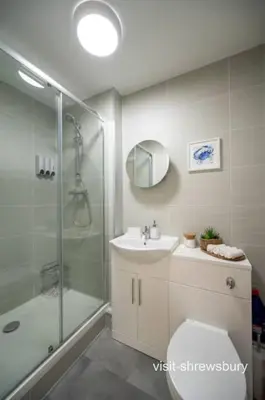 a bathroom with a shower and a toilet and a sink at Personal En-suite in Shrewsbury