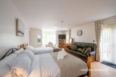 a bedroom with a large bed and a couch at Personal En-suite in Shrewsbury