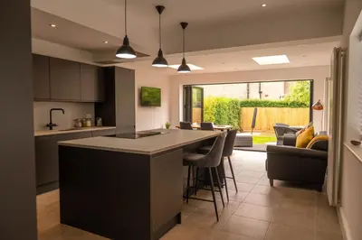 a kitchen and living room with a large island in the middle at Rose Hill in Shrewsbury