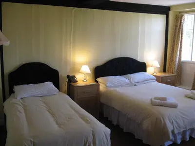 a hotel room with two beds and two lamps at The Red Lion Hotel in Bredwardine