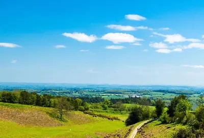 a view of a hill with a train on it at Upper Mowley in Kington