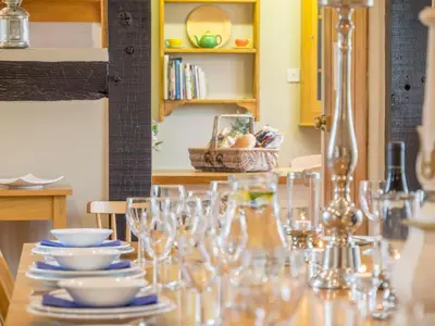 a table with glasses and plates on top of it at Bearwood House & Cottage in Pembridge