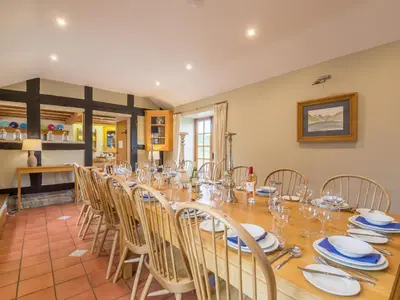 a large dining room with a long table and chairs at Bearwood House in Pembridge