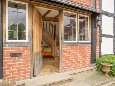 an open door of a brick building with a staircase at Bearwood House in Pembridge