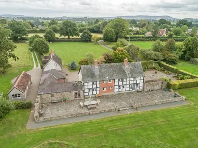 an aerial view of an old house in a field at Bearwood House in Pembridge