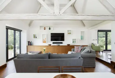 a living room with a couch and a tv at Wassell Barn in Craven Arms