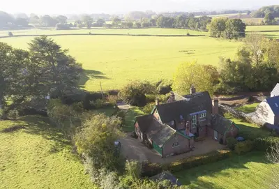 an aerial view of an old house in a field at Green Gables in Eardisley