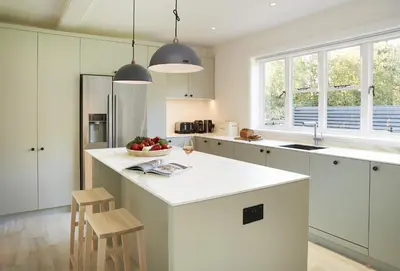 a kitchen with white cabinets and a white counter top at Green Gables in Eardisley