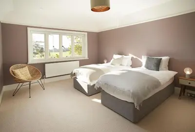 a bedroom with two beds and a window at Green Gables in Eardisley