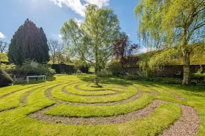 a circular garden with a tree in the middle at The Garden Barn in Peterchurch