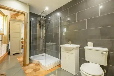 a bathroom with a toilet and a shower at The Garden Barn in Peterchurch