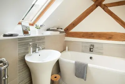 a bathroom with a sink and a bath tub at Unconformity Barn in Hope Bowdler
