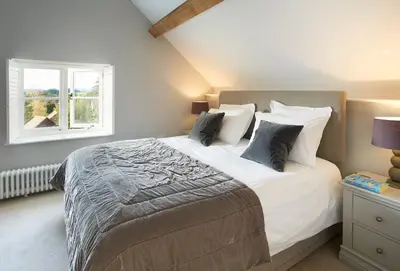a bedroom with a large bed and a window at Unconformity Barn in Hope Bowdler