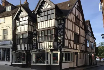 an old black and white building on a street at Evenwood Gables in Kenley