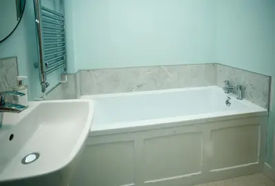 a white bathroom with a sink and a tub at Evenwood Granary in Kenley