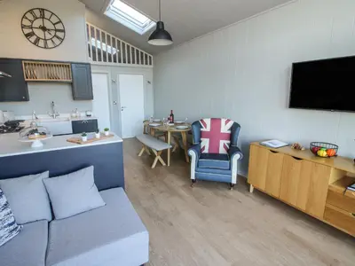 a living room with a couch and a table at Little Shelve Barn in Shrewsbury