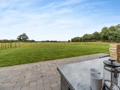 a patio with a table and a field of grass at The Dairy - Uk44130 in Baystonhill