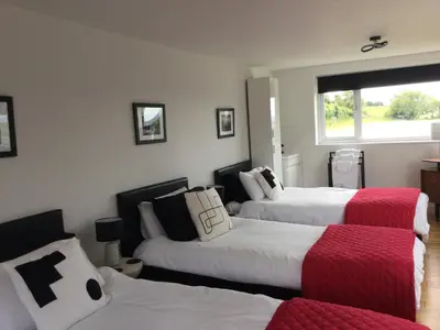 a bedroom with two beds and a window at The Living Energy Holidays in Velindre