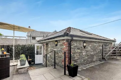 a small brick house with a white door at 1 Bed in Cerrigydrudion oc-bow194 in Cerrig-y-Druidion