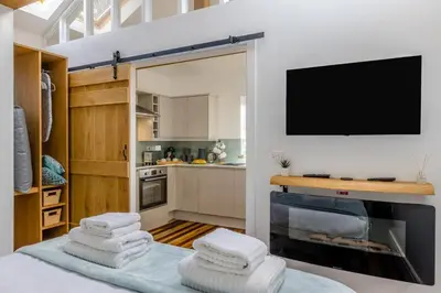 a room with a kitchen with a tv and some towels at 1 Bed in Cerrigydrudion oc-bow194 in Cerrig-y-Druidion