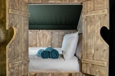 a wooden bed with two blue towels on it at 3 Bed in Talybont-on-Usk oc-wal374 in Talybont