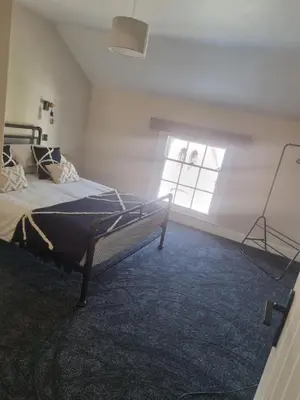 a bedroom with a bed and a window at Grade ll listed holiday home in Llanidloes