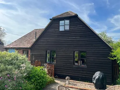 a black house with a gambrel roof at The Annexe at Walnut Tree Cottage in Hope under Dinmore