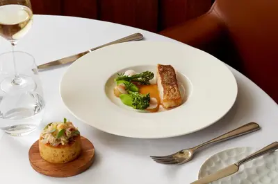 a white plate of food on a white table at Penmaenuchaf Hotel in Dolgellau